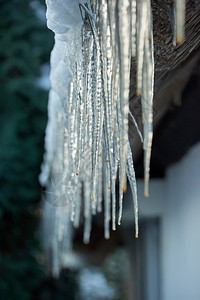 户外冰柱从雪花屋顶上挂下来寒冷的抽象图片