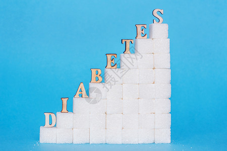 梯子上的糖尿病精炼蓝色背景的尿病导致血和尿病含量上升在高糖层中蓝底染得很多糖会导致血和尿病增加精制糖类钉住图片