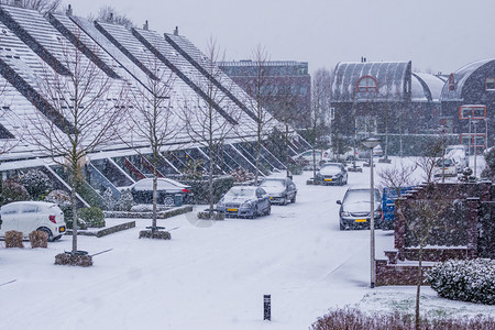 城市的风暴尖在寒冬日暴风雪下冬季现代杜奇人社区在村庄街道上图片