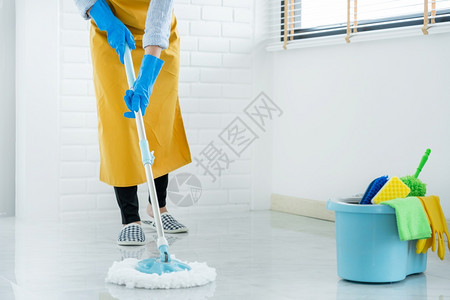 义务青年女管家或拖把清洁地板上洗衣涤戴防护手套家务清洁服女佣活的背景图片