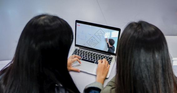 导师视频孩子亚洲学生使用笔记本电脑和平板在科罗纳流行和家中隔离期间在里工作并上线求学背景图片