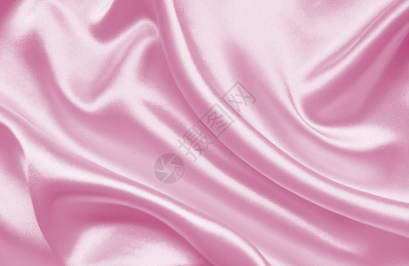 布料纺织品闪亮的平滑优雅粉色丝绸或纹质可用作背景图片
