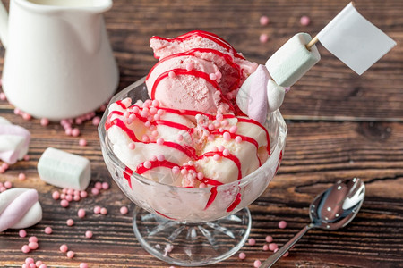 焦糖草莓香蕉和奶油罗马人冰淇淋在玻璃碗里加红酱味道倒了图片