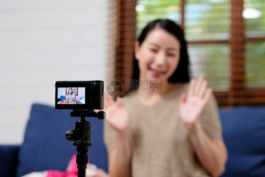 所有者店铺年轻的亚洲博客时装女博客影响者打招呼同时录制新内容用于vlog和时装网上购物在家庭工作室自由职业小企主自由职上用照相机图片
