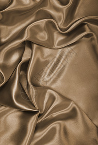 明亮的精美平滑优雅金丝绸或可以用作婚礼背景在SepiatonedRetro风格中使用折痕图片