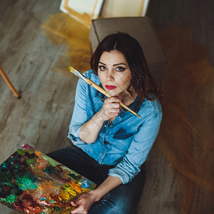 葡萄酒女艺术家在演播室画一幅图片创意的笔记画家女孩在讲习班上用油色绘画布上出色彩多的图画工作室情感图片