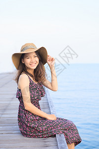 穿着长裙和草帽的美丽女子肖像寻找照相机供人们在天堂旅游目的地度假时使用快乐亚洲女士高清图片素材