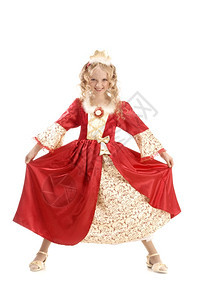 东美丽的笑着容小女孩长金发穿着公主服装展示她的红金帝国礼服在白色背景非常可怕的面孔种族白色的图片