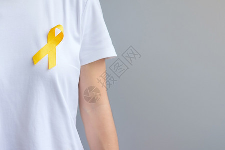 慈善机构九月预防日Sarcoma骨膀胱和儿童癌症意识月支持生活和患病儿童保健世界癌症日概念的黄丝带健康护理和世界癌症日概念团结一图片