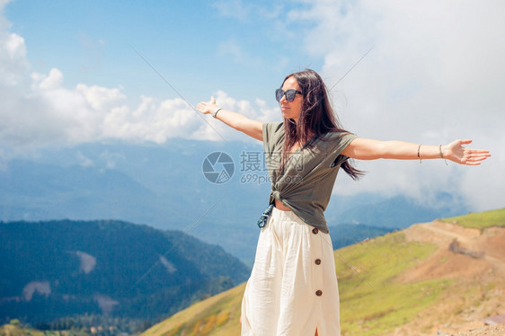 山上美丽的快乐年轻女子在大雾之幕下的山上美丽快乐年轻女士在迷雾中旅行闲暇运动图片