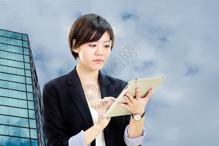 药片数字的金融女商人穿着临时办公室服装在平板电脑上工作有办公室和天文背景图片
