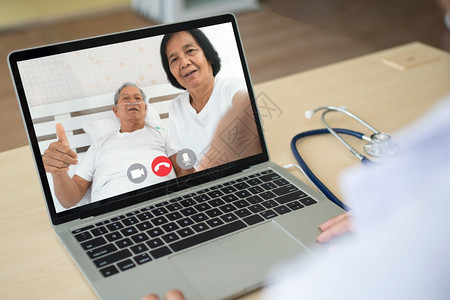 亚洲人与老年病举行医生在线电视会议以监测和询问该疾病的症状并就保健远程医疗和保健概念提供咨询和向老年病人提供医疗远程和保健概念方图片