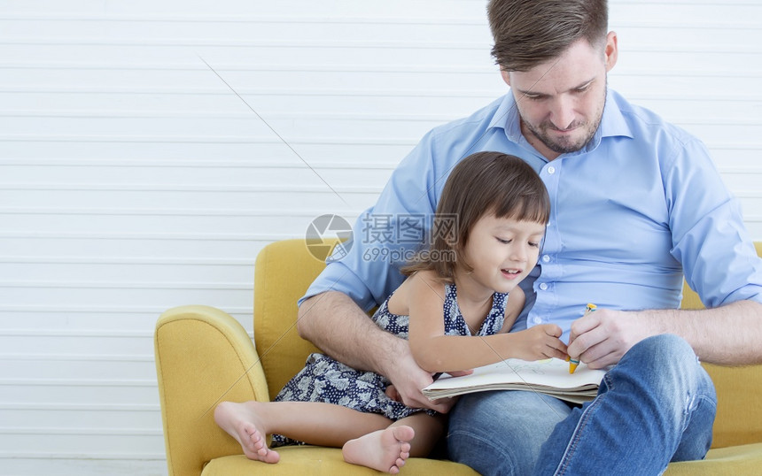 画活动在客厅沙发上坐着时一位天主教的英俊父亲正和女儿一起坐在沙发上屋图片
