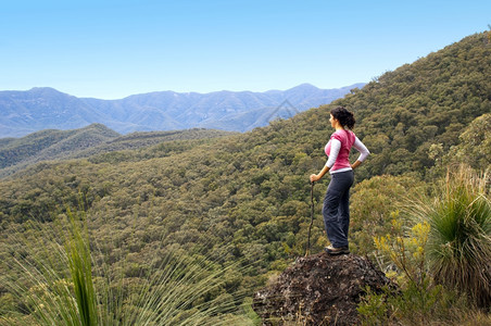 悬崖冒险单身女远足者在山下看望着风景户外图片