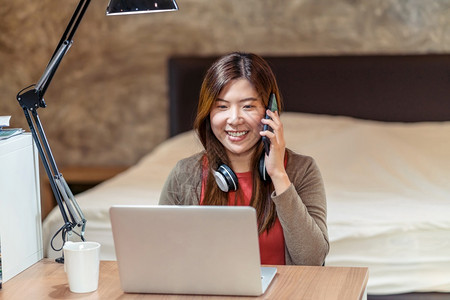 亚洲商业妇女使用技术笔记本电脑在家做卧室电视会议和话创业企主生活方式职业社会失常和自我责任等工作亚洲商业妇女使用技术笔记本电脑并图片