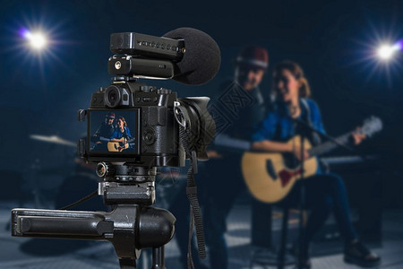曼谷具有麦克风录音像视频博客的专业数字式无镜相机Musicianduo乐队唱一首歌并播放音乐器摄影师或视频和现场流概念Camee图片