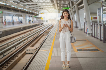 手机人们便携的亚洲青年女乘客在大城市japanesechinese朝韩生活方式和日常通勤和运输概念上旅行时通过地铁火车智能移动电图片