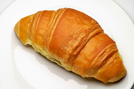 Croissunt 孔滴盘子食物羊角面包糕点早餐背景图片