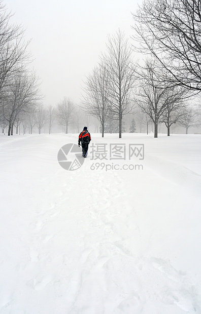 人走在雪路上图片