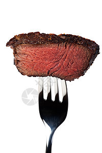 在叉子上烤牛排的一块块棕色食物银器味道牛肉白色营养刀具金属图片