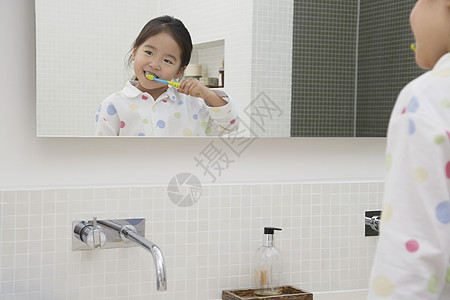 女孩刷牙镜 中的反射图片