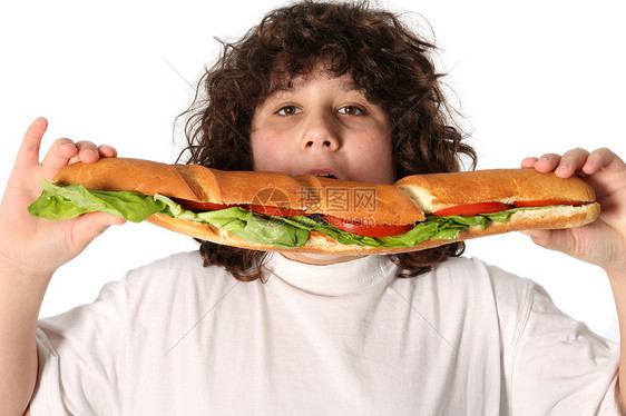 男孩吃大三明治男生童年乐趣营养瞳孔情绪享受学校午餐早餐图片