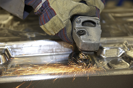 角研磨器劳力体力劳动防护服工作生产手套手工火花工具摩擦背景图片