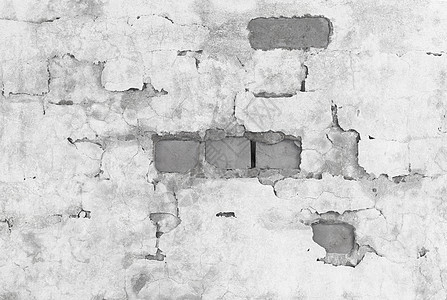 被破碎的石膏覆盖的砖墙图片