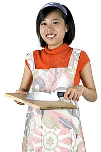 年轻女孩烹饪 切割食物女性女士厨房家务围裙首席背景图片