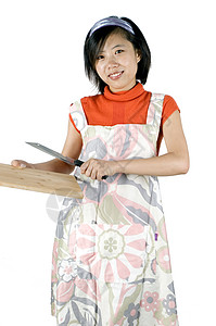 年轻女孩烹饪 切割家务女士首席女性围裙厨房食物背景图片