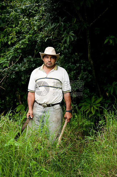 哥斯达黎加牧场的手森林牧场主帽子弯刀男人刀刃国家大男子植物靴子图片