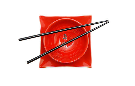 红日日日碗和平板顶视图上的黑筷子图片