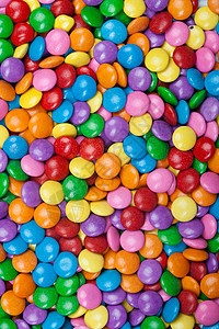 多彩多彩的巧克力糖果橙子绿色蓝色紫色黄色粉色背景图片