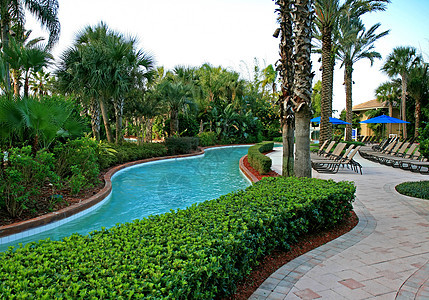 度假村的风景和游泳池棕褐色闲暇酒店乐趣天堂退休棕榈热带晒黑财产图片
