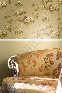 墙旁边有鲜花的旧椅子的一部分 放在墙边图片
