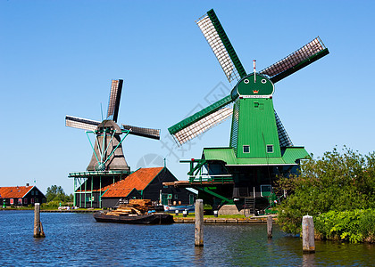 荷兰的磨坊供电铣削文化天空照片活力历史溪流蓝色乡村图片