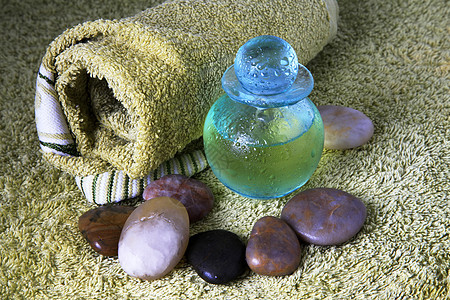 含按摩油的蓝色瓶子精神假期酒店鹅卵石服务冥想产品芳香治疗温泉图片