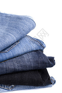 蓝蓝色牛仔裤堆叠阴影织物服装棉布口袋宏观铆钉衣柜裤子折叠图片