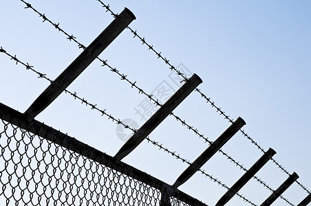 刺理有线围栏监狱危险金属点燃囚犯栅栏蓝色天空安全水平图片