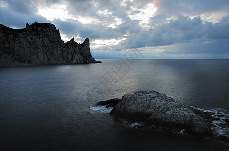 夜间的海地平线日落海浪阳光卵石边缘巨石海滩岩石海景图片