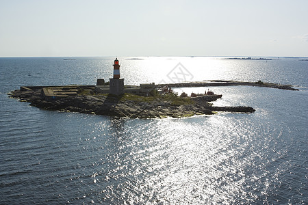 岛上的灯塔太阳海洋日落建筑学背景图片