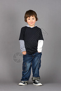 手插口袋的男孩微笑乐趣孩子灰色棕色跑鞋工作室沉思图片
