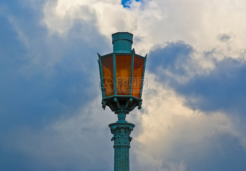 云天背景的古老街灯邮政城市玻璃街道灯柱照明高度辉光铁工历史图片