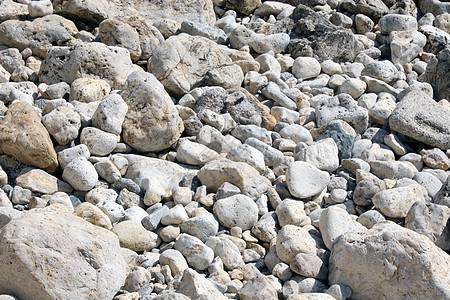 易碎石质岩石材料灰色圆形卵石温泉海岸线石头地面碎石图片