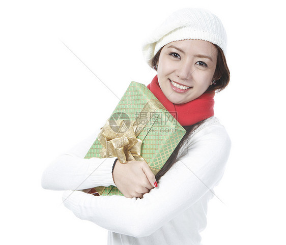 带礼物的年轻女士绿色红色展示女性圣诞礼物毛衣衣服围巾白色金子图片