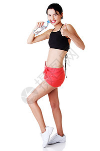 年轻健康妇女饮用矿泉水蓝色保健液体卫生手势女孩运动员微笑运动瓶子图片