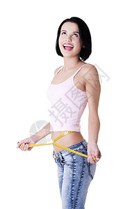 快乐的年轻女子腰部测量牛仔裤减肥女孩女性橘皮腰围组织磁带女士工作室图片