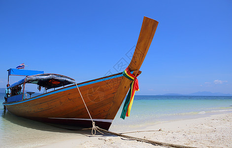 泰国利佩岛沙滩上坐着长尾船热带水晶旅行蓝色天空运输海滩海浪娱乐海景图片