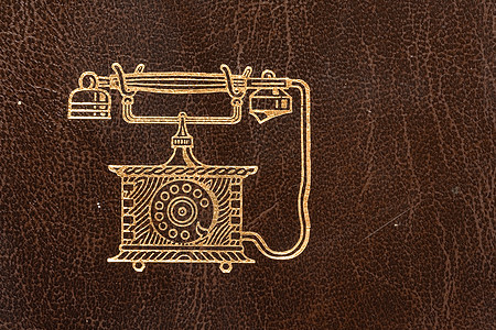 电话簿笔记本水平电话棕色笔记皮革金子背景图片