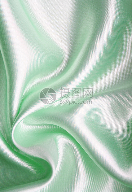平滑优雅的绿色丝绸作为背景曲线织物投标折痕白色银色材料纺织品布料图片